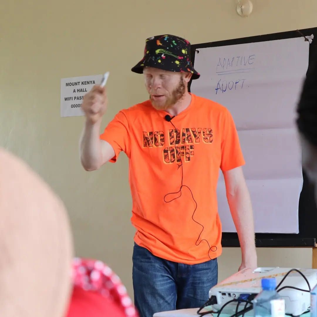 A learner with albinism at work in a classroom.